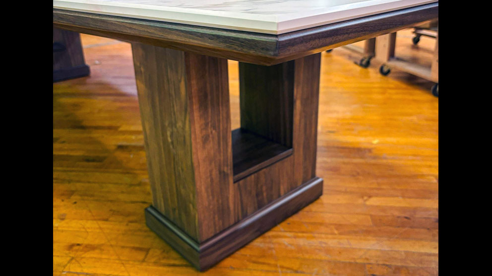 Handcrafted wood pedestal base supporting custom conference table